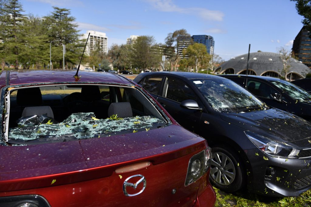 Hail damaged cars are seen parked outside the National Film and Sound Archive of Australia in Canberra, Monday, January 20, 2020. (AAP Image/Mick Tsikas)