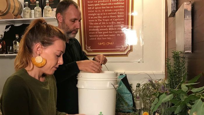 Catie and Warren Brewer prepare botanical mixes for their distilled spirits. (Photo: ABC)