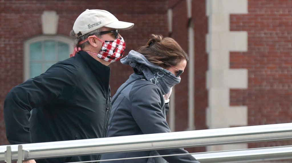 Pedestrians wearing masks due to the coronavirus outbreak in Boston. (Photo: AP Photo/Elise Amendola)
