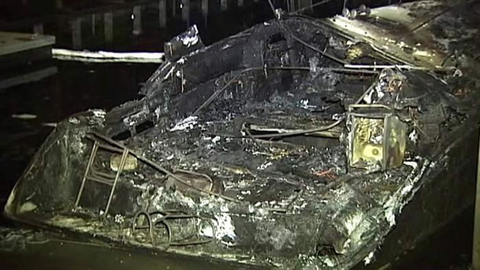 Nearby residents told police they saw three men allegedly throwing liquid on a boat and setting it alight. Photo: ABC