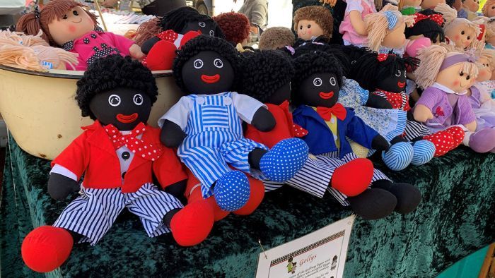 Several dolls, advertised as 'Gollys', at a Toowoomba market stall on June 13. Photo: ABC