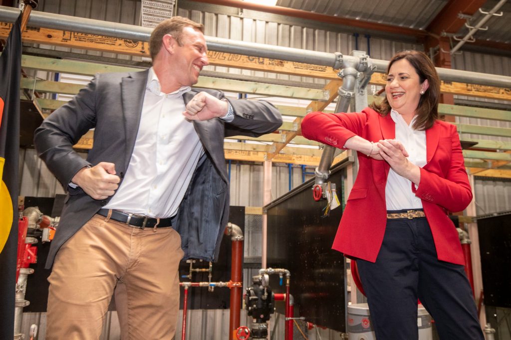 Queensland Premier Annastacia Palaszczuk elbow bumps Deputy Premier Steven Miles at the Queensland Labor election campaign launch. (AAP Image/Glenn Hunt) 