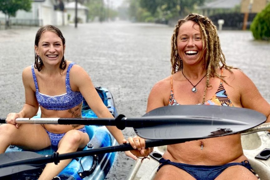 Two women go kayaking in floodwaters at Riverside Drive in Currumbin. Photo: ABC News