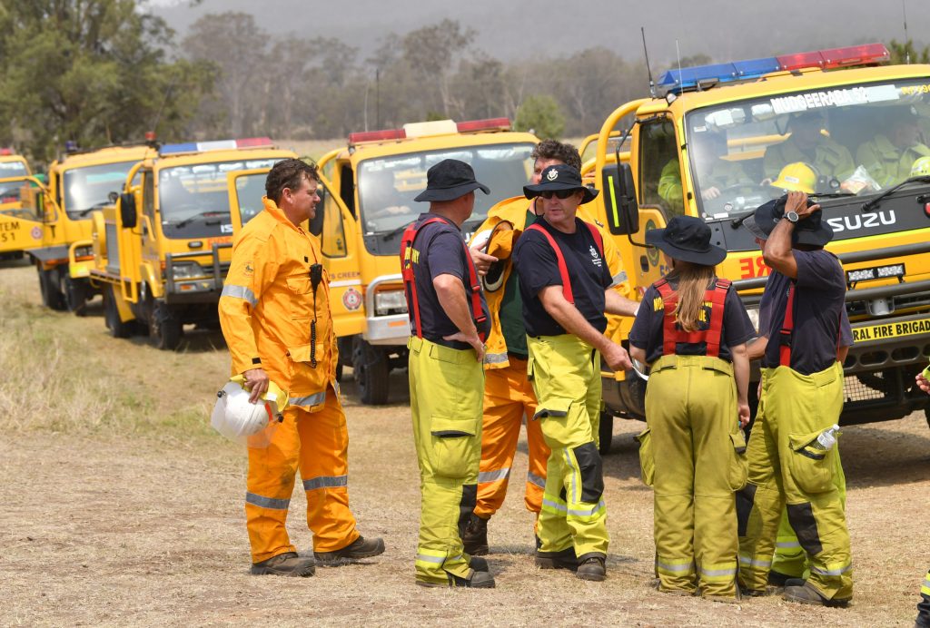 Rural firefighters are seen preparing to fight fires at Spicers Gap, south west of Brisbane, in November 2019 as bushfires began to rage out of control..  (AAP Image/Darren England)