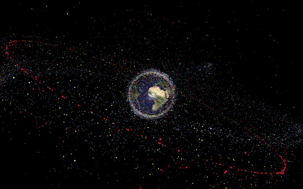 NB: Size of debris exaggerated as compared to the Earth An artist's impression of space debris around Earth. (Source: ESA/PA)