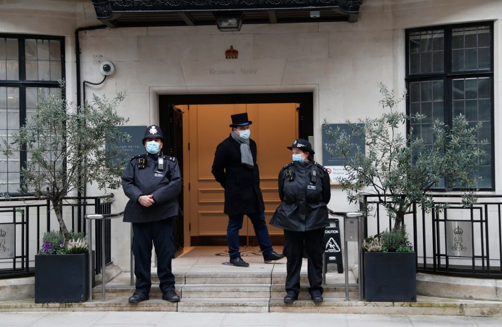 Police stand guard outside the King Edward VII hospital In London, where Britain's Prince Philip is being treated. (AP Photo/Alastair Grant)