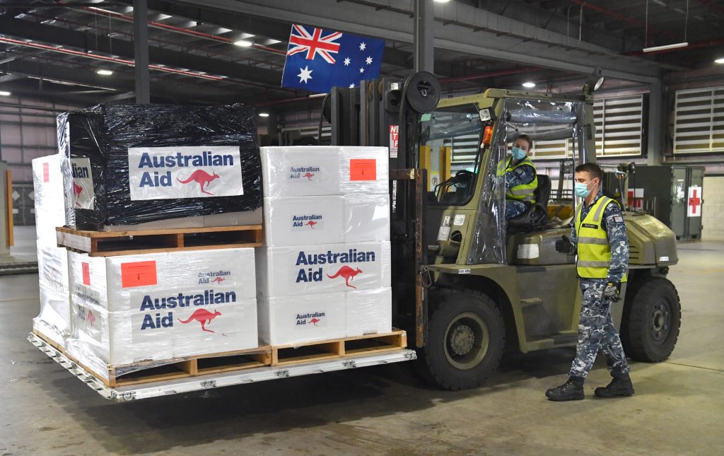 Royal Australian Air Force personal are seen preparing COVID-19 vaccines and humanitarian supplies for loading onto a C-17A Globemaster at RAAF Base Amberley, west of Brisbane, Tuesday, March 23, 2021. Australia are sending 8,000 doses of its COVID-19 vaccine supply to Papua New Guinea who have more than 1,400 active cases of COVID-19 and the Australian government are asking AstraZeneca and European authorities to divert another 1 million doses to Papua New Guinea. (AAP Image/Darren England) NO ARCHIVING