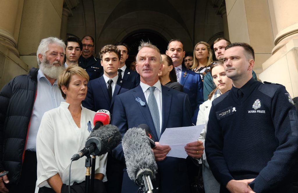 Parents of Josh Prestney, Andrew and Belinda, with brother, Alex Prestney, and other family members outside the Supreme Court of Victoria after truck driver Mohinder Singh was jailed for a maximum of 22 years over the deaths of four police officers on Melbourne's Eastern Freeway in April 2020. (Photo: AAP/Luis Ascui)