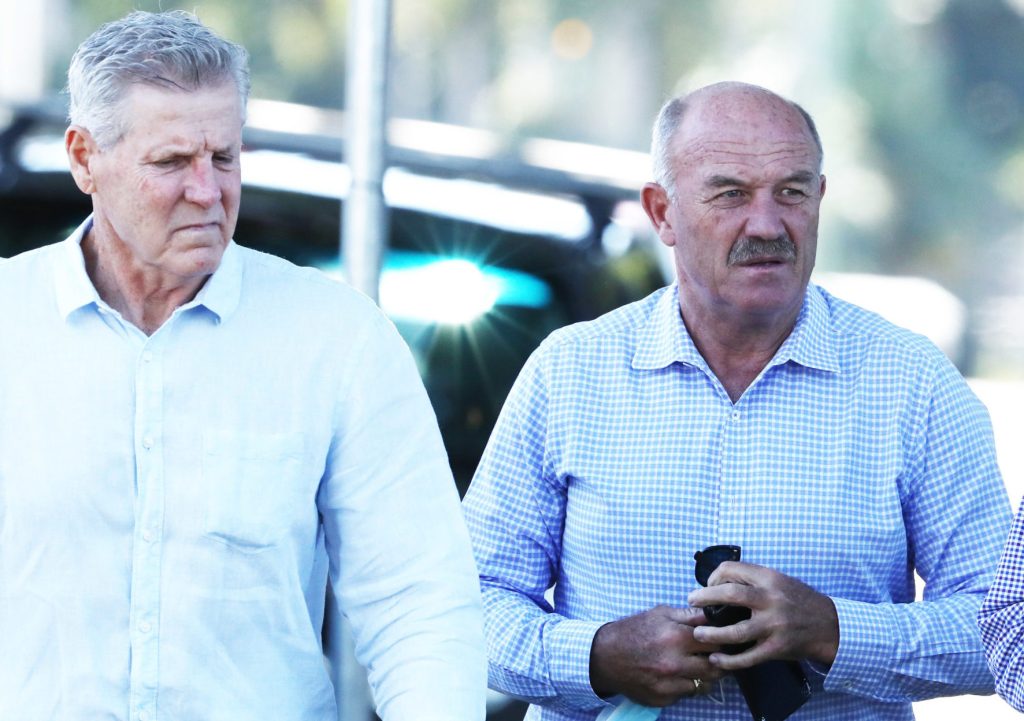 Queensland greats Gene Miles (left) and Wally Lewis attend the funeral for State of Origin rival Tommy Raudonikis at Sacred Heart Catholic Church on the Gold Coast. (AAP Image/Jason O'Brien) 