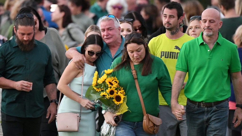 The family of Kelly Wilkinson depart a vigil for murdered mother on the Gold Coast,.  . (AAP Image/Dave Hunt) 