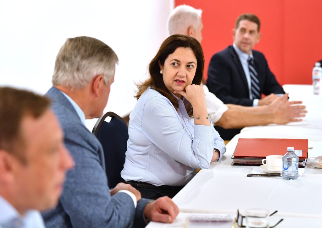 Queensland Premier Annastacia Palaszczuk (centre) and Treasurer Cameron Dick (rear) during a Cabinet meeting at the Qantas Founders Museum in Longreach. (AAP Image/Darren England)