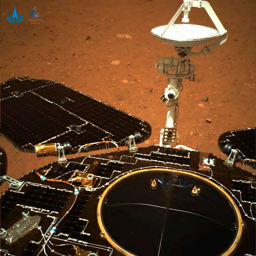 In this photo taken by China's Zhurong Mars rover and made available by the China National Space Administration (CNSA) on Wednesday, May 19, 2021, the rover's solar panels and antenna are deployed as the rover sits on its lander on the surface of Mars. (CNSA via AP)