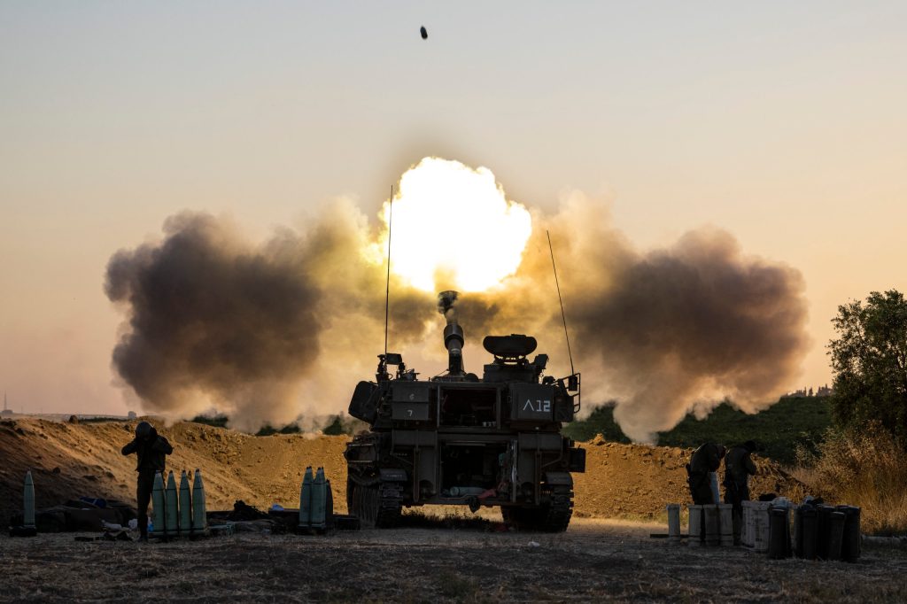 An Israeli artillery unit fires shells towards targets in Gaza Strip, at the Israeli Gaza border. (AP Photo/Tsafrir Abayov)