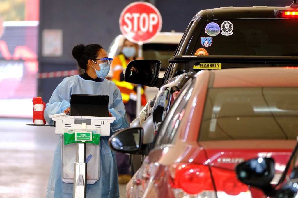 Health workers are seen testing people for Covid19 at Royal Melbourne Showgrounds in Melbourne, Monday, May 24, 2021. Victorian health authorities have been notified of two likely cases of COVID-19 in Melbourne's northern suburbs. (AAP Image/Luis Ascui) 