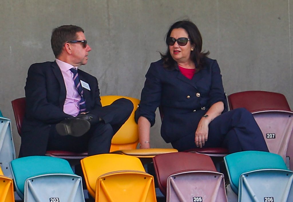Are the Treasurer Cameron Dick and Premier Annastacia Palaszczuk searching behind chairs at The Gabba for more loose change? (AP Photo/Tertius Pickard)