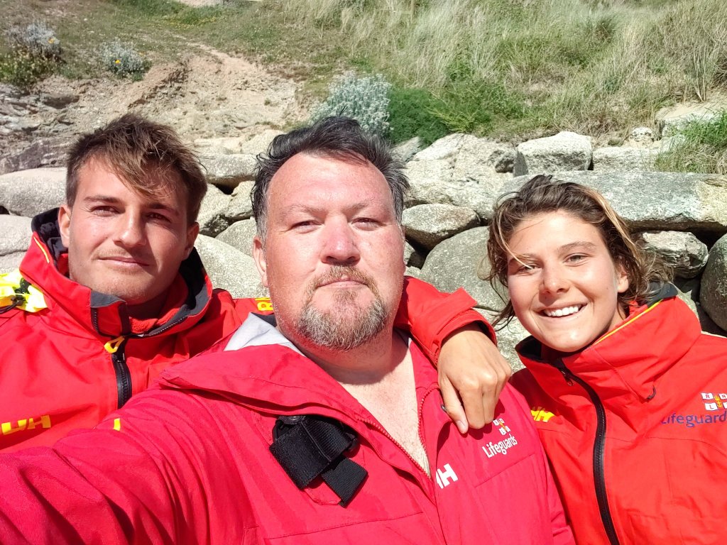 British-based Noosa lifeguard Tori Farmer (right), her fellow Cornwall lifesaver Alex (left) and retired cop Jon Marshall, the man they saved from the treacherous English waters (Image: Supplied)