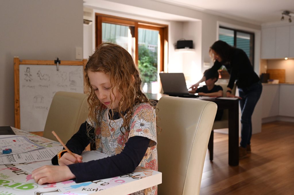 Georgina Coase home schools her daughter Emily and son Samuel in Stanwell Park, Wollongong. Parents enduring homeschooling duties while trying to work during Sydney's virus lockdown say theyt worry how much longer it will go on. (AAP Image/Dean Lewins) 