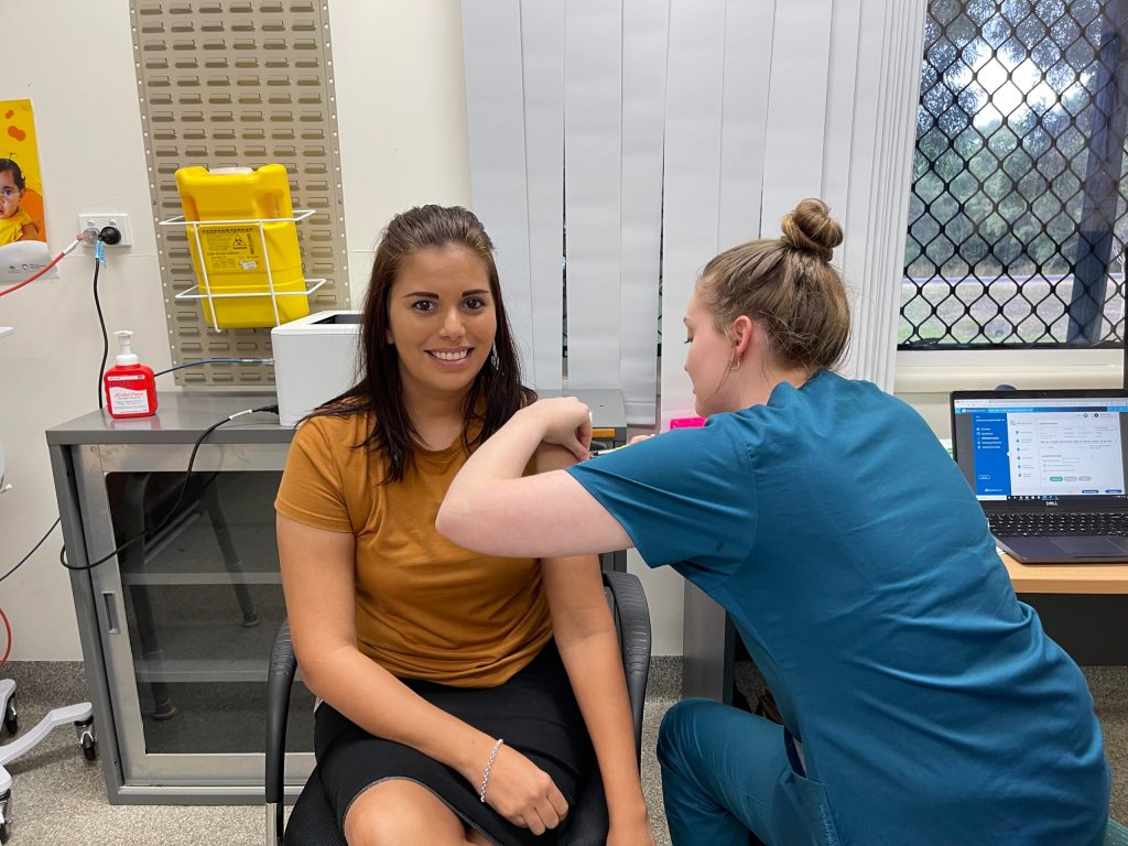 Cooktown Multipurpose Health Service Business Support Officer Desiree Gibson is vaccinated by immunisation nurse Sophie Jones. (Supplied)