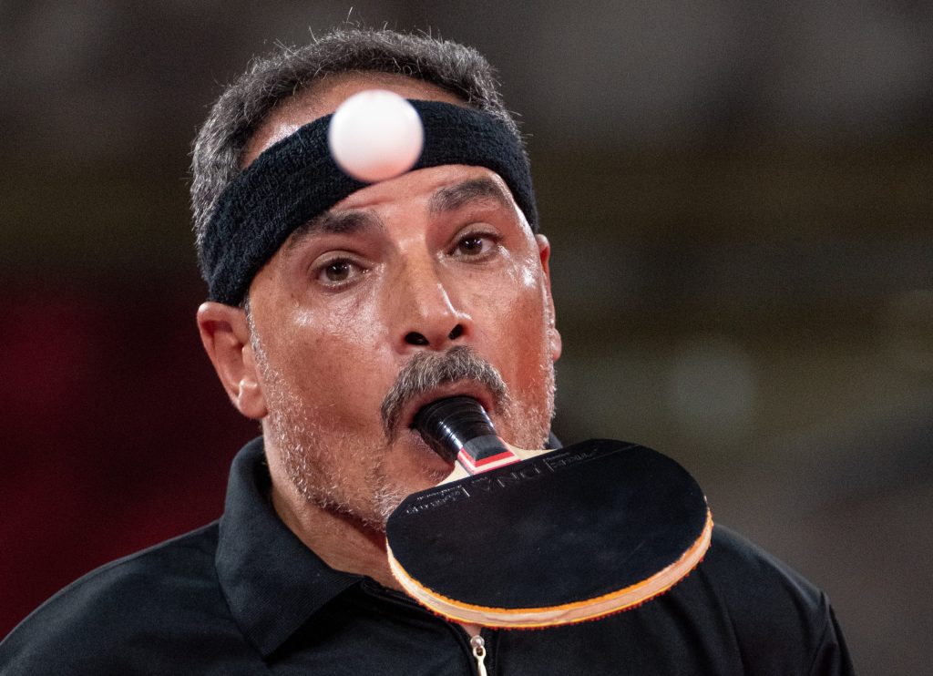 Egyptian table tennis player Ibrahim Elhusseiny Hamadtou, who holds the bat with his mouth and serves with his toes because he has no arms, is typical of the inspiring athletes on show during the Tokyo Paralympic Games, (AAP Image/OIS/ Bob Martin)