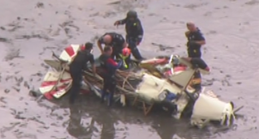 Emergency services attend the scene of a light aircraft crash near Bribie Island, north of Brisbane. (Image: ABC News)