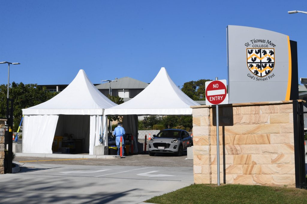Health care workers are seen testing people at a pop-up COVID-19 testing centre at St Thomas More College in the suburb of Sunnybank in Brisbane, Saturday, September 11, 2021. (AAP Image/Darren England) 