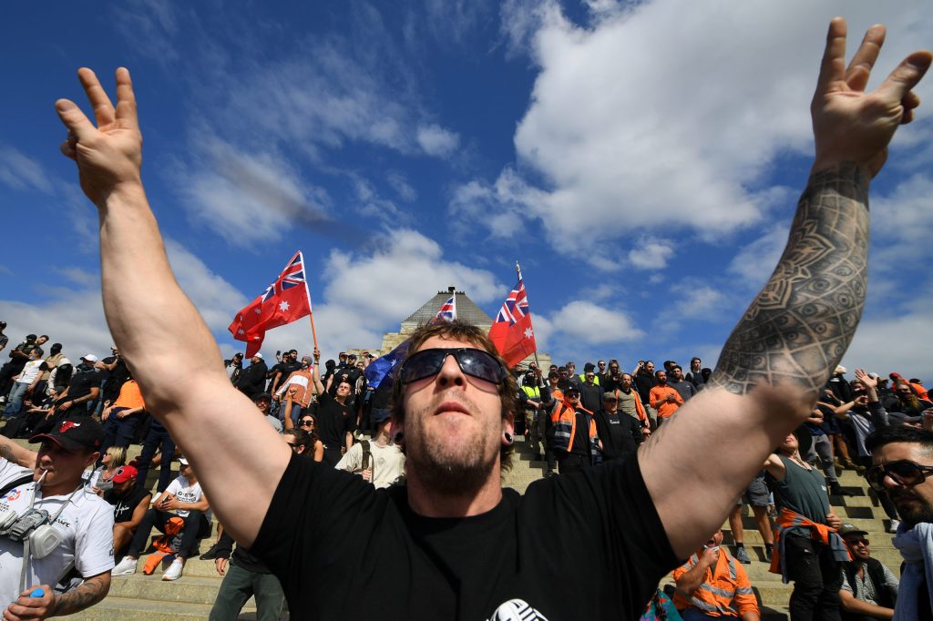 Protesters gather at Melbourne's Shrine of Remembrance as they rally against mandatory Covid-19 vaccinations and a two week shutdown of the construction industry. (AAP Image/James Ross)