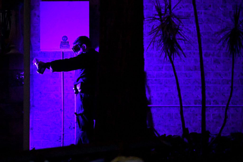 Forensic services use luminol and a blue light to look for blood traces at the front garden of the former home of William Tyrrell’s foster grandmother in Kendall, mid north coast of NSW. Detectives are launching a new search for the remains of missing boy William Tyrrell, seven years after he disappeared on the NSW mid-north coast. (AAP Image/Mick Tsikas) 
