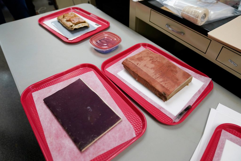 Three books and a coin and envelope were removed from a time capsule that was removed from the pedestal that once held the statue of Confederate General Robert E. Lee. (AP Photo/Steve Helber)