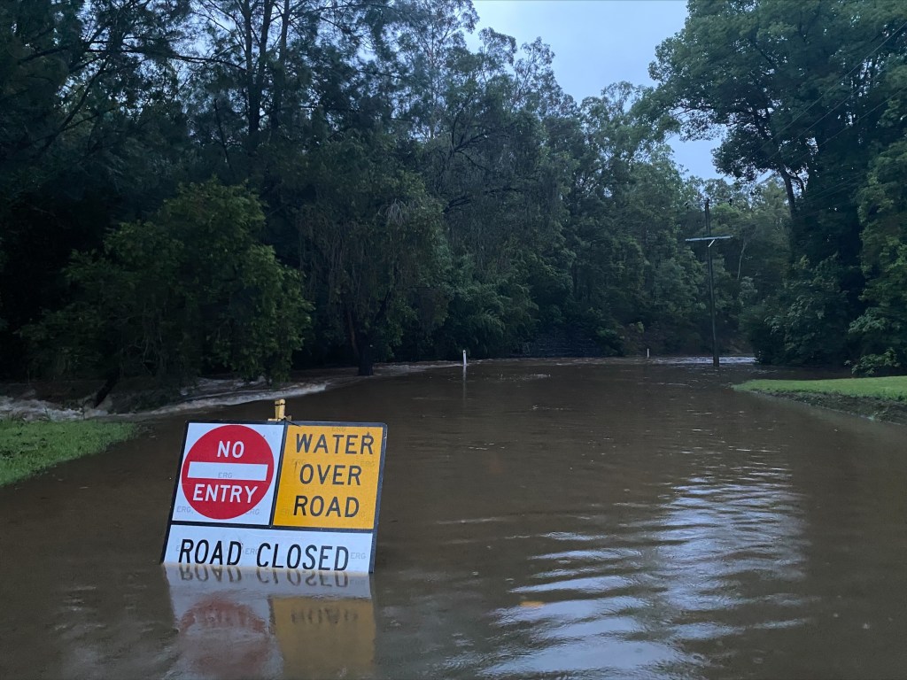 A road inundated by floodwaters at Brookfield in Brisbane's west. (Image: BOM) 