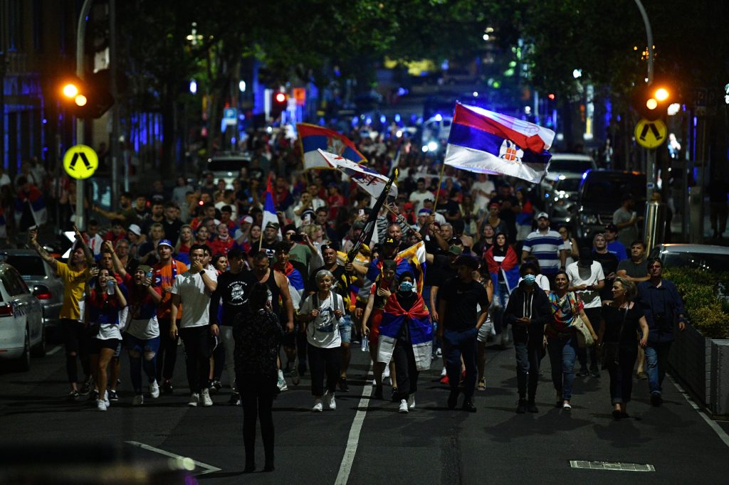 Members of the Serbian community are seen marching in Melbourne, Monday celebrating a decision for Novak Djokovic to be freed from immigration detention after an order by the Federal Circuit Court. (AAP Image/James Ross)