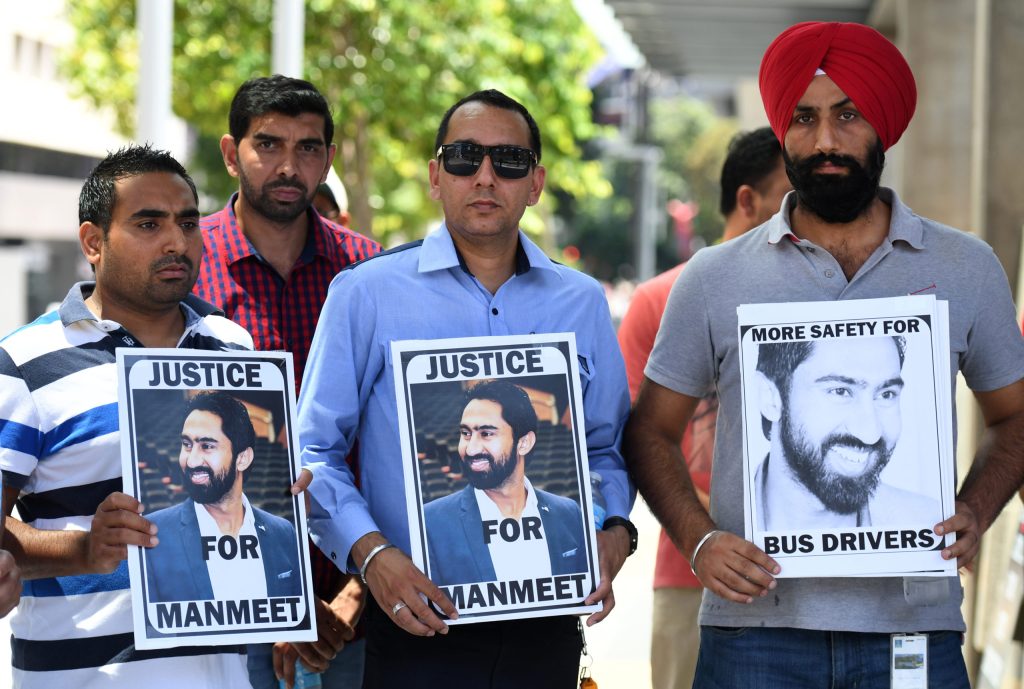 Supporters of murdered bus driver Manmeet  Alisher hold a vigil outside the Magistrates Court in Brisbane. (AAP Image/Dan Peled) 