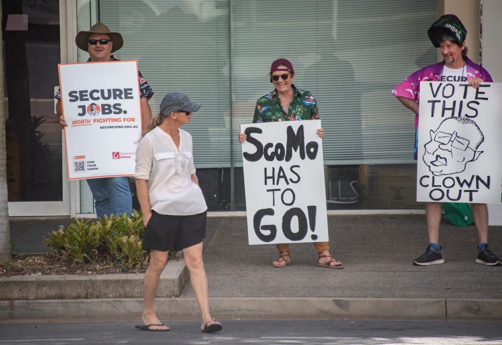 Protesters are seen outside an event attended by Prime Minister Scott Morrison in Cairns, Tuesday (AAP Image/Brian Cassey)