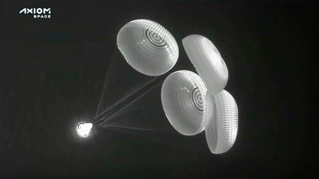 In this image provided by SpaceX, the Dragon space capsule uses parachutes as it descends to the Atlantic Ocean off the Florida coast on Monday, April 25, 2022. Three rich businessmen returned from the International Space Station with their astronaut escort, wrapping up a pricey trip. (SpaceX via AP)