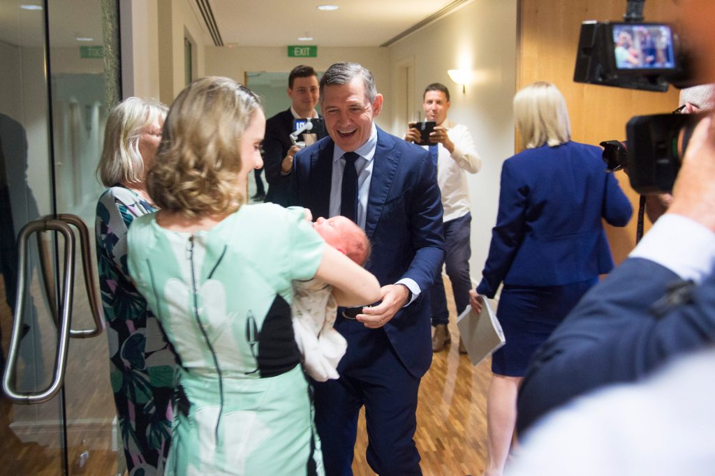 Northern Territory Chief Minister Michael Gunner with family after announcing his retirement during a press conference, in Darwin, Tuesday, May 10, 2022. Northern Territory Chief Minister Michael Gunner has resigned, saying he knew it was time to go when he held his new baby son in his arms. (AAP Image/Aaron Bunch) NO ARCHIVING