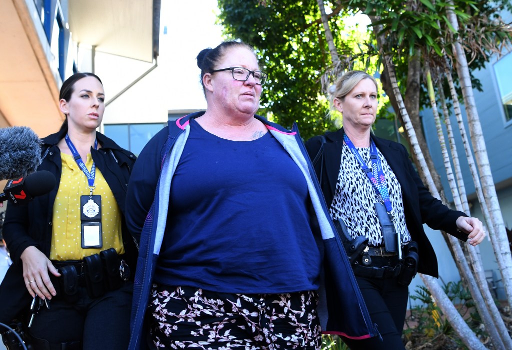 Shannon White (centre) is taken from the Morningside police station after she was arrested in Brisbane, Wednesday, June 3, 2020. Ms White has been charged with the murder of her four-year-old stepdaughter Willow Dunn. (AAP Image/Dan Peled) 