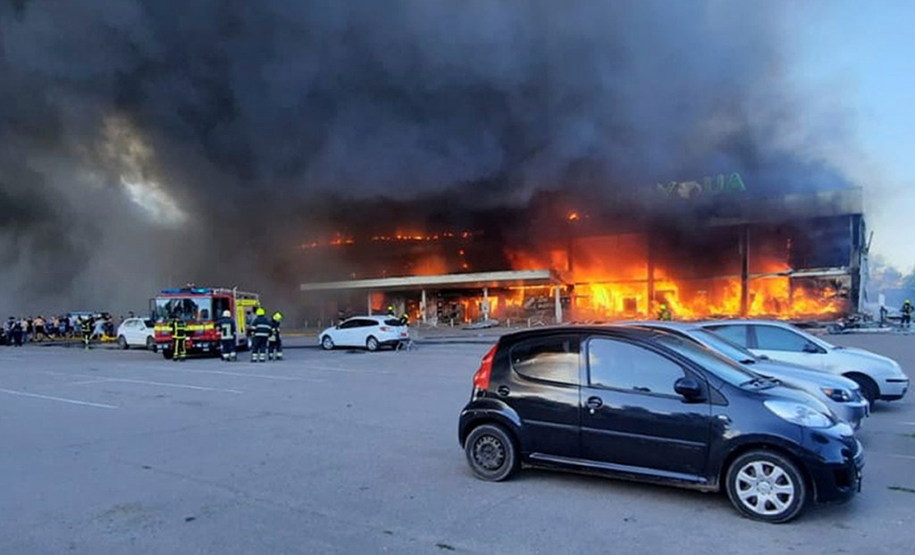 In this image made from video provided by Ukrainian State Emergency Service, firefighters work to extinguish a fire at a shopping center burned after a rocket attack in Kremenchuk, Ukraine, Monday, June 27, 2022. (Ukrainian State Emergency Service via AP)