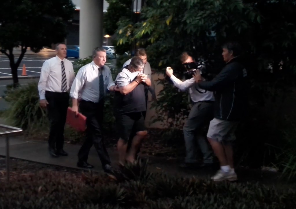 Gregory Lee Roser (in shorts) after being arrested. Roser, 63, and Sharon Graham, 61, are on trial after being charged with the murder of Bruce Saunders. (AAP Image/Supplied by QLD Police) 