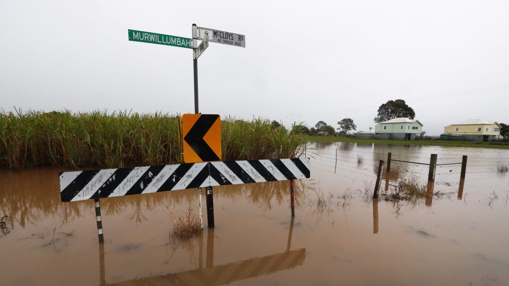 Floodwaters west of Condong near the town of Murwillumbah,. A low-pressure storm system that caused flooding across inland NSW earlier this week tracked towards the coast with flood and storm warnings covering much of the state's east. (AAP Image/Jason O'Brien) 