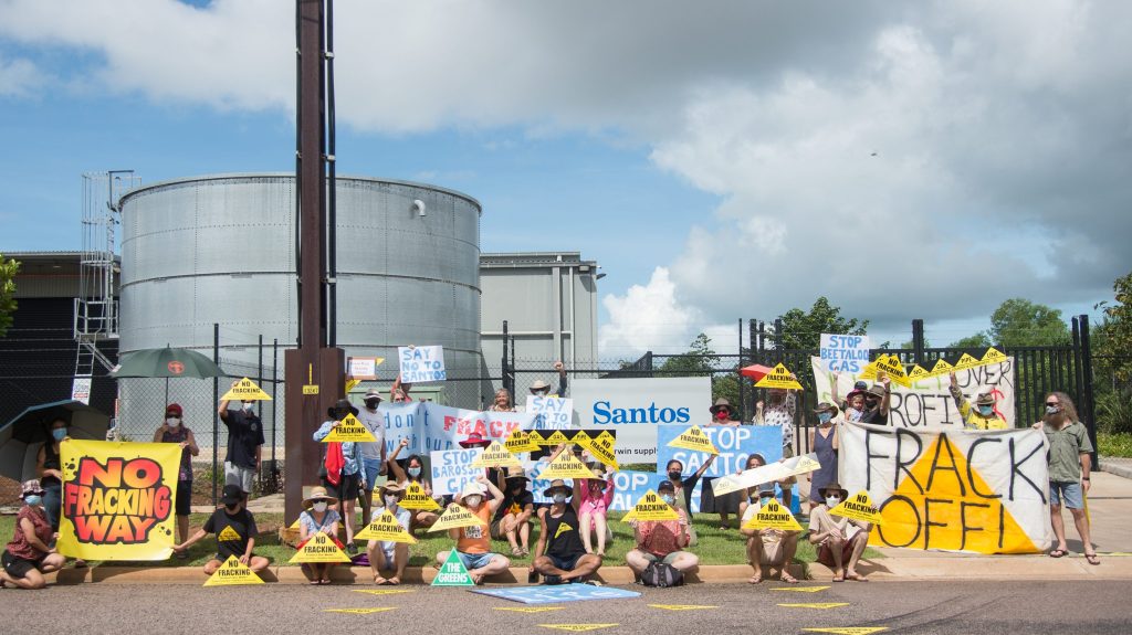 Protesters gathered outside Santos's East Arm premises to voice their concerns over the gas producer's Northern Territory projects, in Darwin. Protesters say the nation's second-largest independent gas producer is attempting to greenwash its Northern Territory gas project. (AAP Image/Aaron Bunch) 