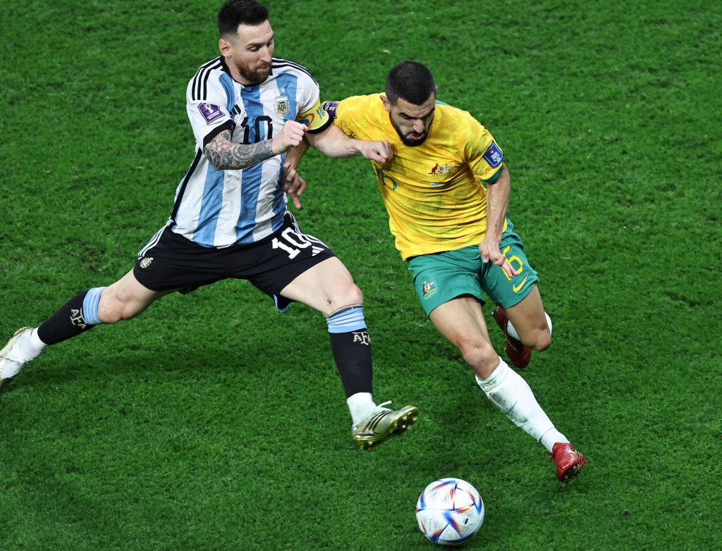 Argentine superstar Lionel Messi (L) fights for the ball against Australia's Aziz Behich (R) during the Qatar 2022 World Cup football match. Argentina beat Australia 2-1 and will play the Netherlands in the quarter-finals on Friday.(Photo By Liu Zhankun/ColorChinaPhoto) Color China Photo/AP Images
