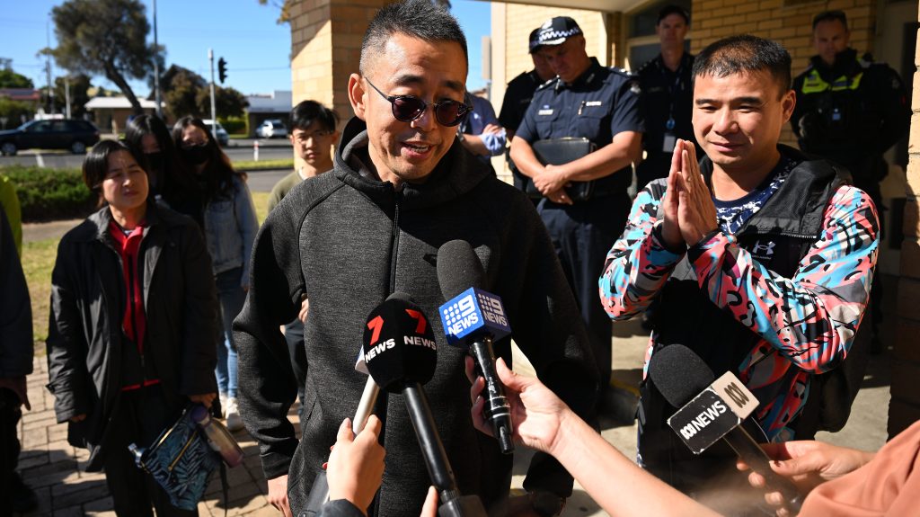 Jack Shi (centre), father of one of the discovered teenagers departs after speaking to media in Rosebud on the Mornington Peninsula. (AAP Image/James Ross) 