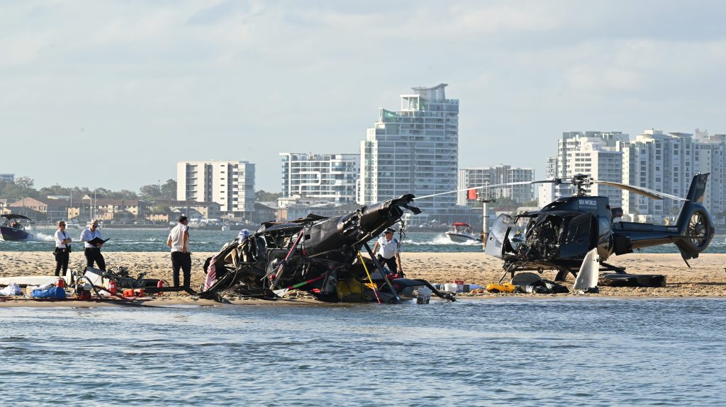 Four people died and another 13 were injured after two helicopters collided before one crashed into the Broadwater on the Gold Coast. (AAP Image/Dave Hunt) 