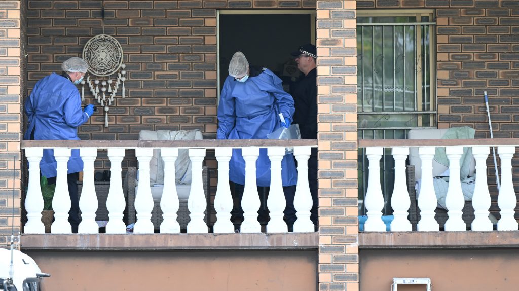 Police are seen at the scene of a small fire and wounding at the Grange in Brisbane, Thursday, February. Emergency crews were called to an Inglis Street home just before 5.30 where they located a small fire and a man with an alleged stab wound who was transported to hospital with critical injuries. (AAP Image/Darren England)