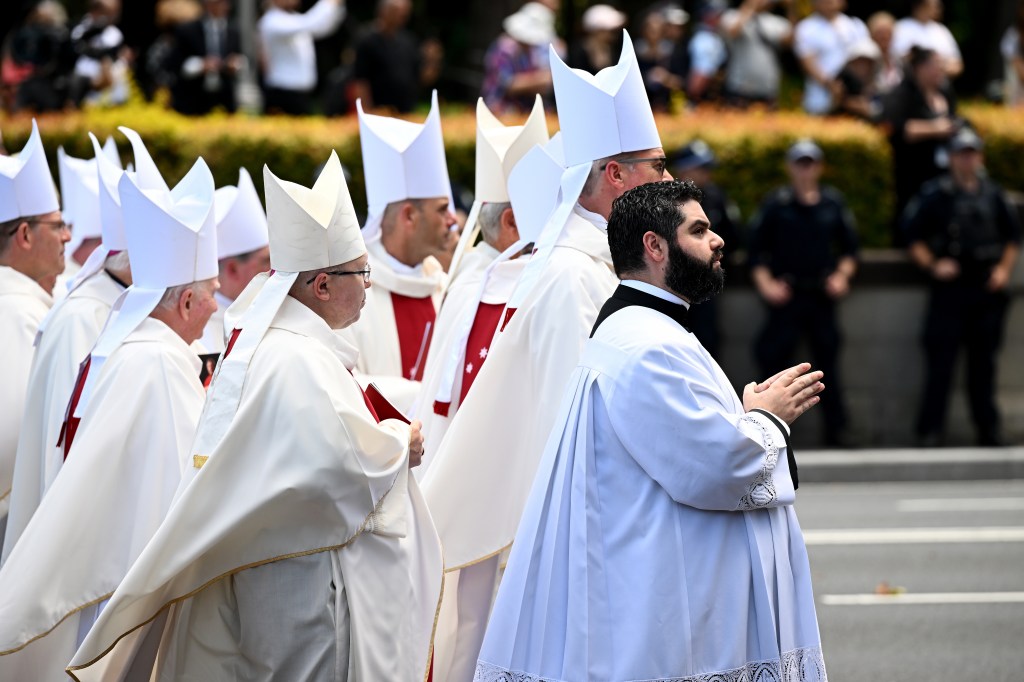 The procession to the crypt following a pontifical requiem Mass for Cardinal George Pell at St. Mary's Cathedral in Sydney. (AAP Image/Dan Himbrechts)