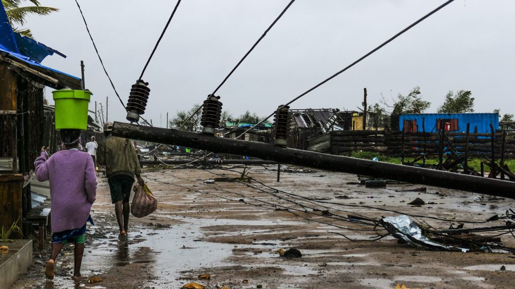 People walk on a flooded street near Quelimane, as the storm Freddy hits Mozambique, 12 March 2023. With a radius of about 300 kilometres Freddys is one of the longest lasting storms ever, after it formed at the beginning of February in the Asian seas, crossing the entire Indian Ocean to the east African coast.  EPA/ANDRE CATUEIRA