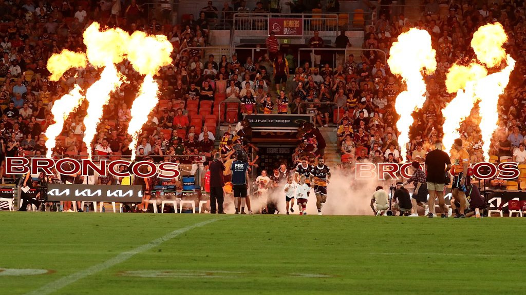 Adam Reynolds leads the Broncos out onto the Suncorp Stadium playing surface.  (AAP Image/Jason O'Brien) 