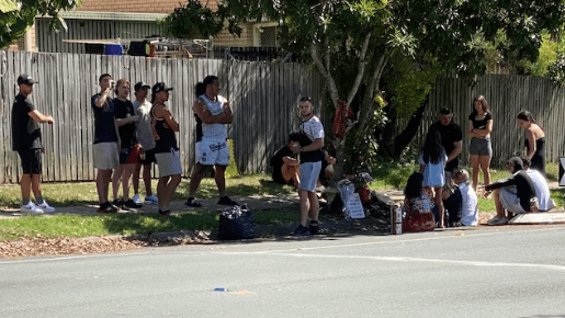 Friends gather at the scene where a 17-year-old dirt bike rider died in an alleged hit-run near Brisbane. (Image ABC).