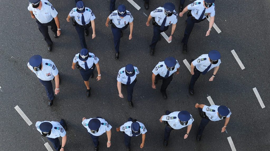 Members of the Queensland Police march in the Brisbane CBD. (AAP Image/Dave Hunt) 