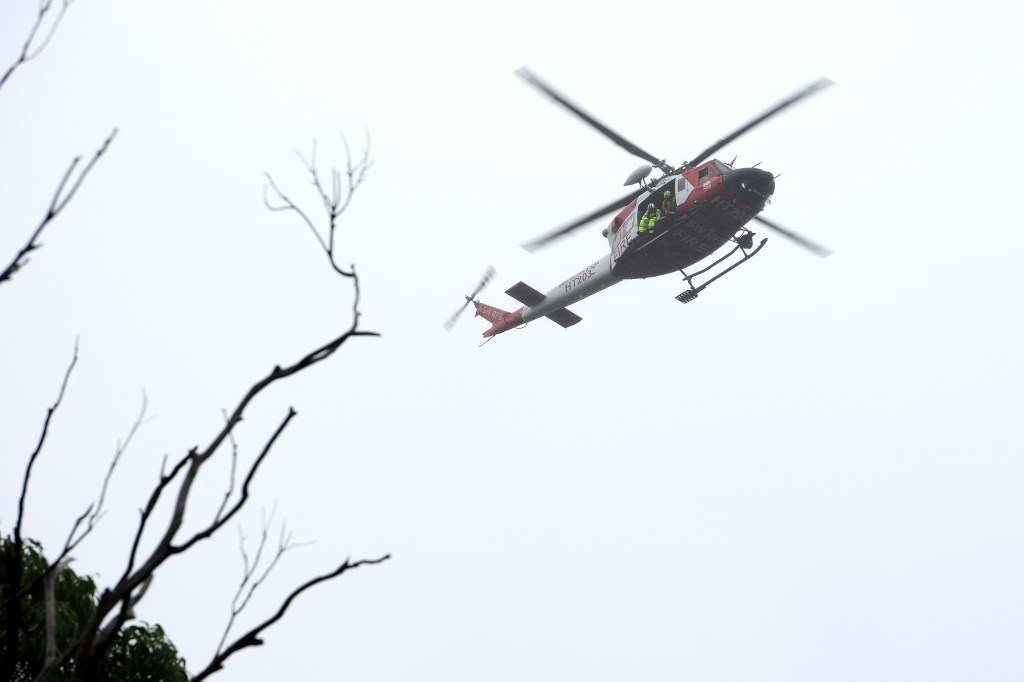 A search by helicopters and fixed-wing aircraft resumed Monday for a plane missing with two people on board near Proserpine.(AAP Image/Dan Himbrechts) 