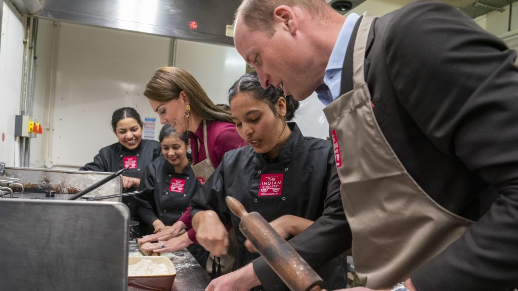Britain's Kate, Princess of Wales and Prince William roll out dough, during a visit to The Indian Streatery, an authentic, family run independent Indian restaurant based in Birmingham, England, Thursday, April 20, 2023. (Arthur Edwards/Pool Photo via AP)